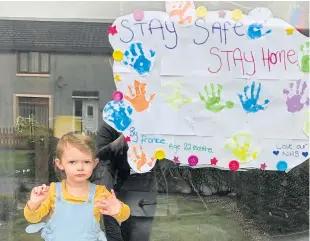  ??  ?? Frankie Quinn, who is 22 months old, from Glenrothes, sends a little love from his window. The bereaved family receive support from CHAS.