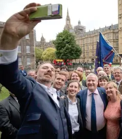  ??  ?? MP Chris Law takes a selfie alongside SNP Westminste­r leader Ian Blackford, centre, surrounded by the party’s MPs Photograph: PA Wire