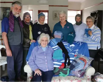  ??  ?? Dr Mark Marais with the members of the Happy Hands Knitting group, Kobie Pietersen, Clare Sheard, Miranda Luckhoff, Denise Weldon, Joy Sharpe and (front) Dot Hobson. They are seen here with the beanies, scarves and other handmade items knitted for mariners.