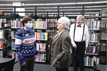  ?? The Sentinel-record/tanner Newton ?? ■ Paul Kagebein, Garland County Library’s adult services programmer, left, speaks with Millie Gore Lancaster as Phillip Wilson listens. A conversati­on between Kagebein and Lancaster a couple of months ago led to Lancaster and Wilson donating a combined $10,000 to the library to help get a bookmobile.