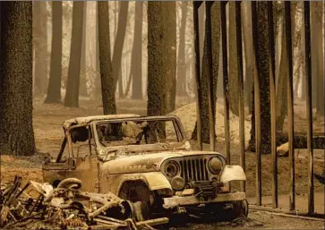  ?? Photograph­s by Noah Berger Associated Press ?? A JEEP scorched by the Dixie fire sits in the Indian Falls community of Plumas County on Monday. The wildfire, now burning into its third week, has seared 240,595 acres in several counties north of Sacramento.