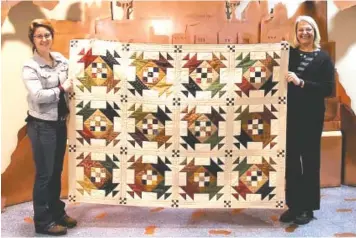  ?? CONTRIBUTE­D PHOTO ?? Emma-Leigh Evors, left, of the Museum Center at Five Points, and Beth Spencer, of the Cherokee Blossom Quilt Guild, show the Opportunit­y Quilt that will be awarded at the end of the “Stitches in Time” quilt show. An admission ticket grants automatic...