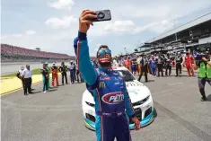  ??  ?? Wallace takes a selfie with other drivers that pushed his car to the front in the pits.