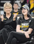  ?? Charlie Neibergall The Associated Press ?? Iowa’s NCAA Division I recordsett­ing guard Caitlin Clark, right, learns that her No. 22 jersey will be retired.