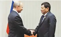  ??  ?? RUSSIAN President Vladimir Putin and Philippine President Rodrigo R. Duterte meet for the first time at the APEC Summit in Peru, Nov. 19.