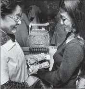  ?? Ken Hively
Los Angeles Times ?? FRANCES HASHIMOTO, right, rings up sales with her mother, Haru, in 1978 at the Little Tokyo store owned by Mikawaya, a 105- year- old family business.