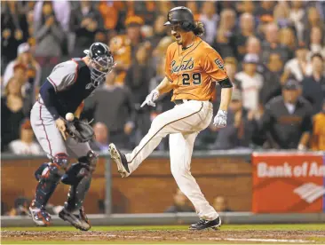  ?? LACHLAN CUNNINGHAM/GETTY IMAGES ?? The Giants Jeff Samardzija crosses home plate to score in the fourth inning Friday against Atlanta at AT&T Park