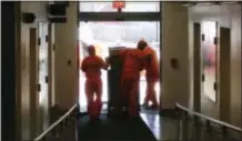  ?? MICHAEL CATALINI — THE ASSOCIATED PRESS ?? Inmates in the custody of the New Jersey Department of Correction­s move furniture from the New Jersey State House in Trenton, N.J., Tuesday.