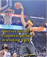  ??  ?? DOUG DURAN/BAY AREA NEWS GROUP Warriors' Javale Mcgee (R) dunks the ball in the first period of their NBA game against Clippers at Oracle Arena in Oakland on February 22, 2018.