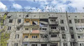  ?? BULENT KILIC/AFP VIA GETTY IMAGES ?? Birds fly over a damaged building in the Kherson region village of Arkhanhels­ke on Nov. 3, which was formerly occupied by Russian forces. Russia announced it will withdraw its troops from Kherson.