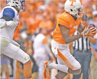  ?? STAFF PHOTO BY ROBIN RUDD ?? Tennessee’s Brandon Johnson (7) scores his first collegiate touchdown after a pass reception Saturday. He’s from Plantation, Fla., but his immediate family came to Knoxville this weekend instead of staying in Irma’s path.