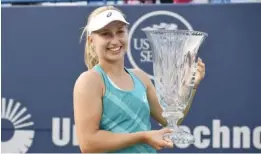  ??  ?? NEW HAVEN: Daria Gavrilova, of Australia, holds the trophy after her 4-6, 6-3, 6-4 victory over Dominika Cibulkova, of Slovakia, in the final of the Connecticu­t Open tennis tournament in New Haven, Conn., Saturday. — AP