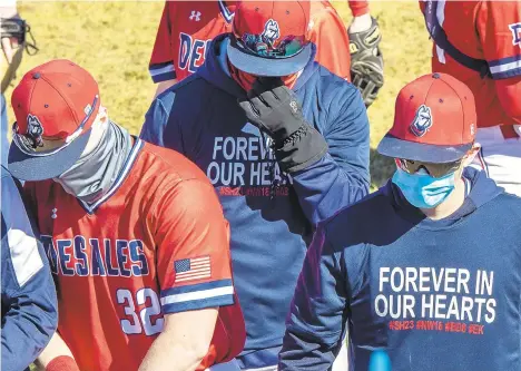  ?? APRIL GAMIZ/THE MORNING CALL ?? The team huddles together during a DeSales baseball game against Misericord­ia. The team was honoring victims of a tragic car crash that killed a player, a former player and his girlfriend, and left another player critically injured.