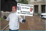  ?? — AFP ?? WASHINGTON: A protester stands outside the E Barrett Prettyman US Courthouse on Jan 9, 2023, during a hearing on immunity for former US President Donald Trump.