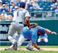  ?? Photo by John Sleezer/Kansas City Star ?? Kansas City Royals’ Kendrys Morales is tagged out by Texas Rangers shortstop Elvis Andrus in a rundown during the sixth inning Sunday in Kansas City, Mo.