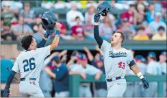  ?? ?? UConn’s Matt Donlan (43) celebrates with T.C. Simmons after hitting a three-run home run against Stanford during the second inning of Saturday night’s Super Regional opener in Stanford, Calif. The Huskies won 13-12.