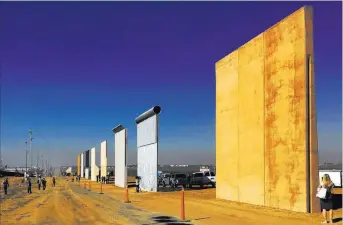  ?? Elliott Spagat ?? Prototypes of border walls in San Diego. A U.S. official said testing of the prototypes found their heights should stop crossers.
The Associated Press