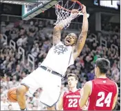  ?? REY DEL RIO / GETTY IMAGES ?? Michigan State’s Nick Ward dunks for two of his teamhigh 22 points in the Spartans’ Big Ten upset of No. 16 Wisconsin on Sunday.