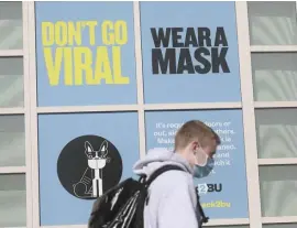  ?? NICOLAuS CzARnECkI / hERALD StAFF FILE ?? ‘A GIANT STEP’: A sign in a window urges students, ‘Don’t go viral, wear a mask,’ outside Boston University last month. BU said it hopes to go back to almost complete in-person learning in the fall.