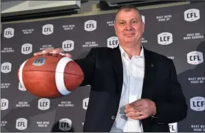  ?? THE CANADIAN PRESS/FRANK GUNN ?? Randy Ambrosie holds a football as he speaks during a press conference in Toronto, Wednesday. The CFL says Ambrosie will serve as the 14th commission­er in league history.