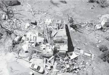  ?? JAIME GREEN/THE WICHITA EAGLE ?? Tornado’s wrath: A home destroyed by a tornado is seen Saturday in Andover, Kansas. Officials said the twister hit southeast Wichita and Andover on Friday evening. They also said several people were injured and thousands were left without power. Andover Fire Chief Chad Russell said 50 to 100 buildings were damaged in Sedgwick County.