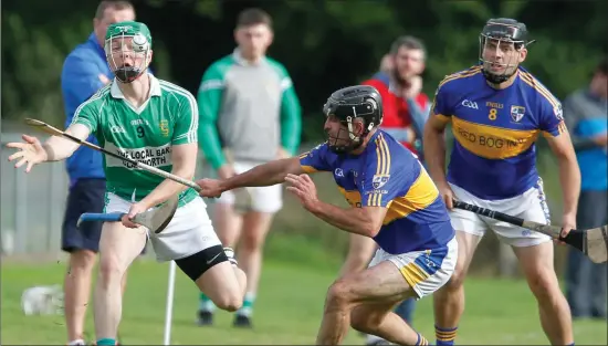  ??  ?? Harbour Rovers’ Sean O’Finn gets a pass away past the attempted block from Dromina’s Mike Naughton in their North Cork JAHC Quarter-final. Photo by Eric Barry