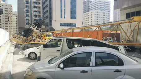  ?? Abu Dhabi Police; Pawan Singh / The National ?? The mobile crane was dismantlin­g the boom of a larger crane when it fell, say witnesses