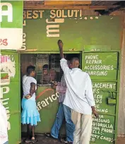  ?? Picture: Getty Images ?? SUCCESS STORY: Residents transfer money using M-Pesa in Nairobi, Kenya