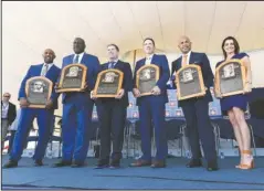  ?? The Associated Press ?? NEW HALL OF FAMERS: National Baseball Hall of Fame inductees Harold Baines, Lee Smith, Edgar Martinez, Mike Mussina, Mariano Rivera and Brandy Halladay, window of the late Roy Halladay, hold their plaques for photos Sunday after the induction ceremony at Clark Sports Center in Cooperstow­n, N.Y.