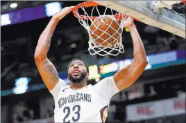  ?? Gerald Herbert ?? The Associated Press Pelicans forward Anthony Davis dunks in the first half for two of his 53 points Monday in New Orleans’ 125-116 win over the Suns at the Smoothie King Center.