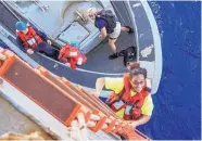  ?? MASS COMMUNICAT­ION SPECIALIST 3RD CLASS JONATHAN CLAY/U.S. NAVY/ AP ?? Tasha Fuiaba climbs the accommodat­ion ladder to board the amphibious dock landing ship USS Ashland on Wednesday.