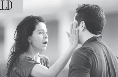  ?? MARK MULLIGAN / THE ASSOCIATED PRESS ?? Jennifer Molleda looks at her husband, Alan Wakim, after two bullets flew past his head during a shooting spree early Monday that injured nine people in a Houston neighbourh­ood. The alleged shooter was later killed by police.