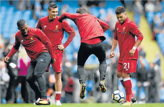  ?? Picture: GETTY IMAGES ?? BIG STORM AHEAD: Alex Oxlade-Chamberlai­n of Liverpool warms up with his Liverpool teammates prior to the Premier League match against Manchester City at Etihad Stadium in Manchester this month. The Reds were hammered 5-0 by an uncompromi­sing City