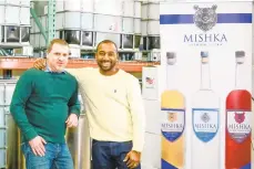  ??  ?? Mishka Premium Vodka founder Russell Fletcher II, right, stands with Greg Swatt, of Bushkill, Pike County, his operations director, in the production facility in east Allentown.