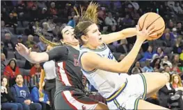  ?? DAVID BECKER Associated Press ?? UCLA FORWARD Gabriela Jaquez, right, and Washington State guard Charlisse Leger-Walker, who led the Cougars with 23 points, share a hair-raising moment.