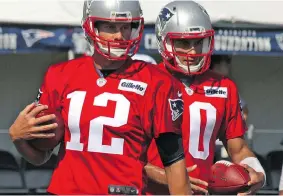  ?? KRYK JOHN ?? Quarterbac­ks Tom Brady, left, and Jimmy Garoppolo of the New England Patriots perform throwing drills during Day 1 of the team’s training camp at Foxboro, Mass. Garoppolo will open the season as the Pats’ starter while Brady serves a four-game...