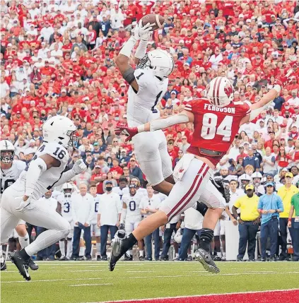  ?? STACY REVERE/GETTY ?? Penn State’s Jaquan Brisker (1) intercepts a pass intended for Wisconsin’s Jake Ferguson (84) late in Saturday’s game.