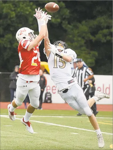  ?? Lindsay Perry / For Hearst Connecticu­t Media ?? Greenwich’s Nick Veronis breaks up a pass intended for Trumbull’s Kyle Atherton during a Sept. 8 game at Cardinal Stadium in Greenwich.