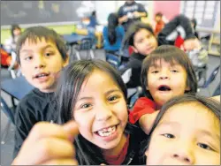  ?? CP PHOTO ?? In this file photo, Grade 2 students are excited to have their photo taken at the Eenchokay Birchstick School on the Pikangikum First Nation. Pikangikum First Nation is a remote-access community located on Pikangikum Lake, approximat­ely 100 km northwest of Red Lake, Ont. Ontario Health Minister Eric Hoskins is announcing funding for 20 full-time mental health workers for the remote community struggling with a suicide crisis and pressing mental health needs from about 380 people seeking counsellin­g.