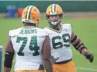  ?? MARK HOFFMAN/MILWAUKEE JOURNAL SENTINEL ?? Packers guard Elgton Jenkins (74) and left tackle David Bakhtiari confer during the team’s 2020 training camp.
