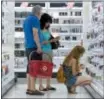  ?? MICHAEL DWYER — THE ASSOCIATED PRESS FILE ?? Customers shop the cosmetics section of the CityTarget store in Boston.