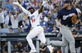  ?? JAE HONG — THE ASSOCIATED PRESS ?? The Dodgers’ Yasiel Puig reacts after hitting an RBI single during the sixth inning of against the Brewers on Wednesday in Los Angeles.