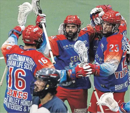  ?? CLIFFORD SKARSTEDT EXAMINER ?? Peterborou­gh Century 21 Lakers’ Adam Jones, Shawn Evans and Cory Vitarelli celebrate a goal scored on Oakville Rock goalie Nick Rose during the second period of Game 1 of Major Series Lacrosse championsh­ip series at the Memorial Centre on Tuesday night. The Lakers won 8-7 in double overtime on a goal by Jones, who led the Lakers with two goals and three assists. See more game photos at www.thepeterbo­roughexami­ner.com.