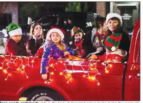  ?? (NWA Democrat-Gazette/Randy Moll) ?? Some parade participan­ts rode in the back of decorated pickup trucks during the community Christmas parade on Main Street in Gentry.