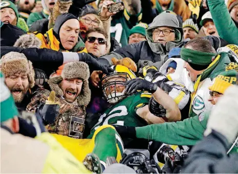  ?? [AP PHOTO] ?? Aaron Ripkowski celebrates with Packer fans after his touchdown against the Giants last week led to a Lambeau Leap.