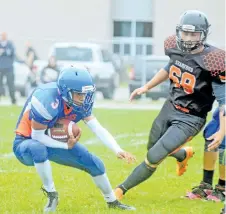  ??  ?? Welland Centennial Cougars defensive back Michael Thornton, left, intercepts the ball in senior Division 1 Niagara public high school football action Friday against the Stamford Hornets in Welland.