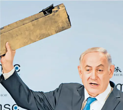  ??  ?? Benjamin Netanyahu pictured yesterday, holding aloft an alleged Iranian drone wing