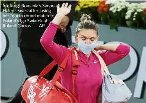  ??  ?? So long: Romania’s Simona Halep leaves after losing her fourth round match to Poland’s Iga Swiatek at Roland Garros. — AP