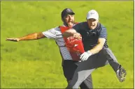  ?? Maddie Meyer / Getty Images ?? Jordan Spieth celebrates with caddie Michael Greller after chipping in for birdie from a bunker on the 18th green to win the Travelers Championsh­ip in a playoff against Daniel Berger on June 25, 2017.