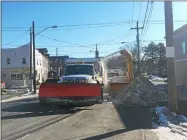  ?? NICHOLAS BUONANNO -MEDIANEWS GROUP FILE ?? Crews from Cohoes Department of Public Works are seen out on Columbia Street last year removing large snow banks from the side of the street.